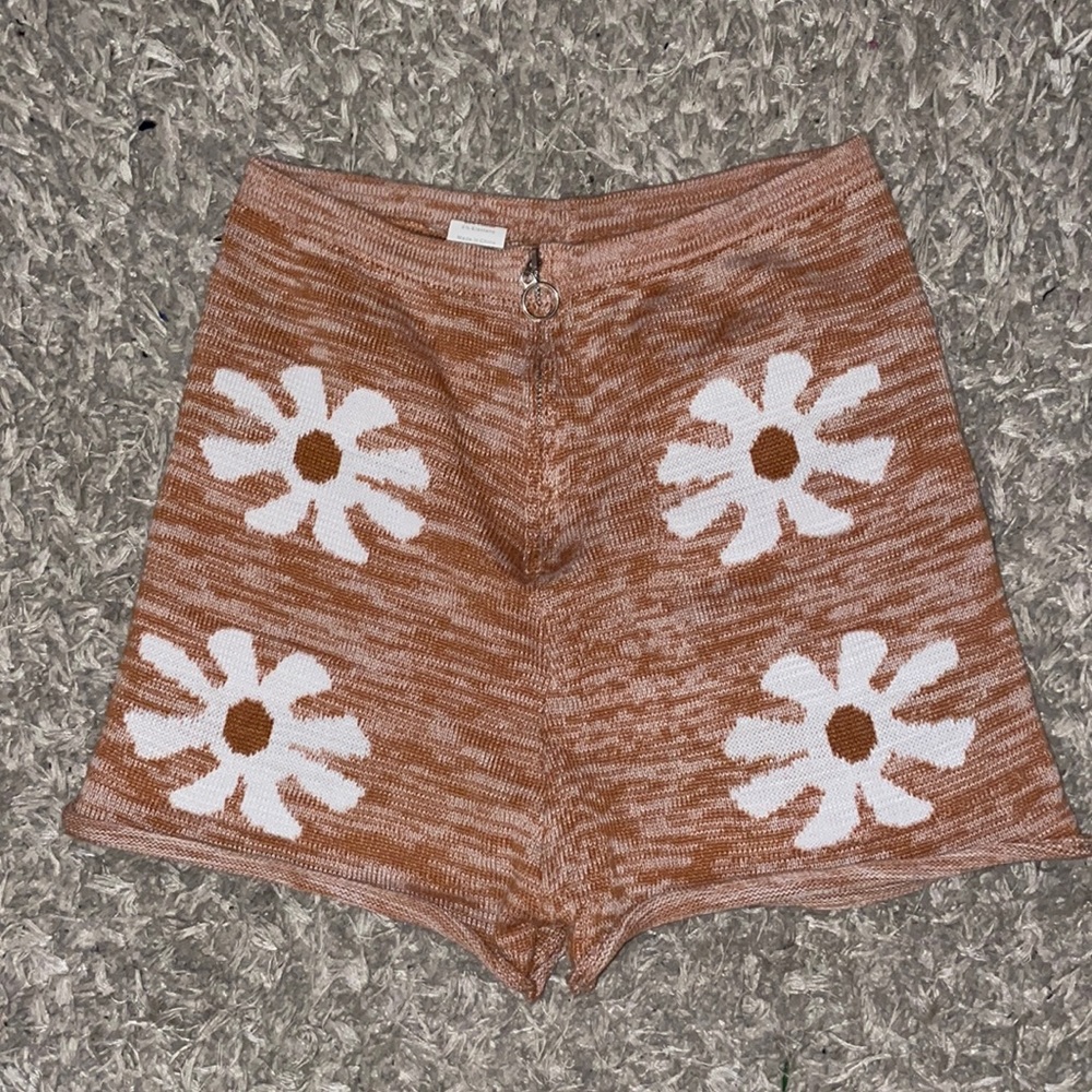 Coral shorts with white flowers on front and back, small silver circle zipper